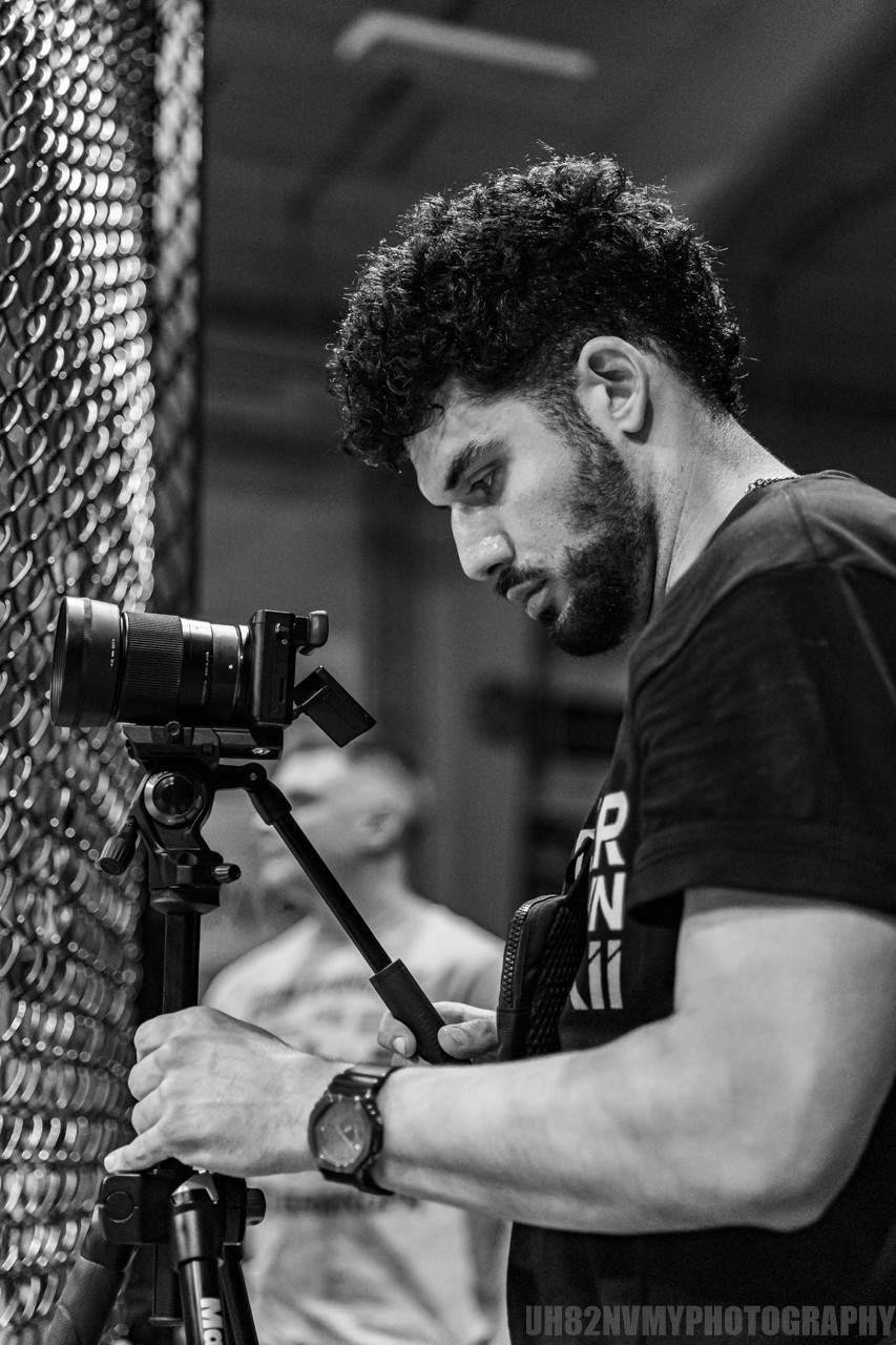 STGM owner filming through the cage at a fight event